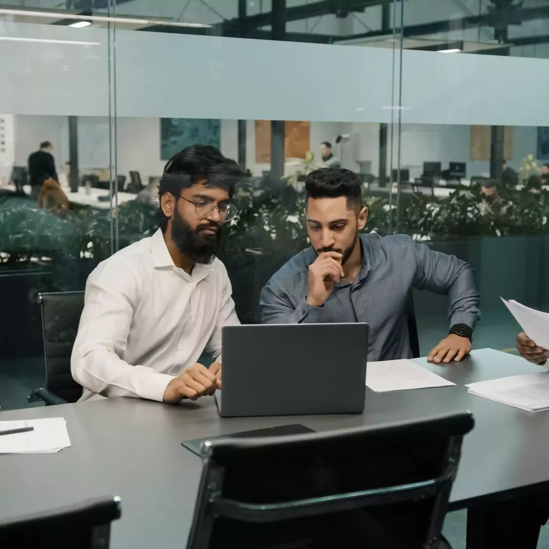 Professionals collaborating at a laptop